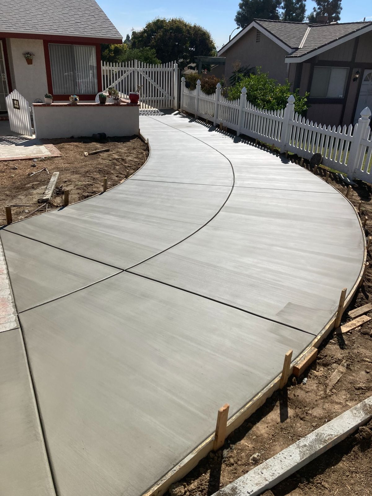 Freshly poured curved concrete walkway still in its forms