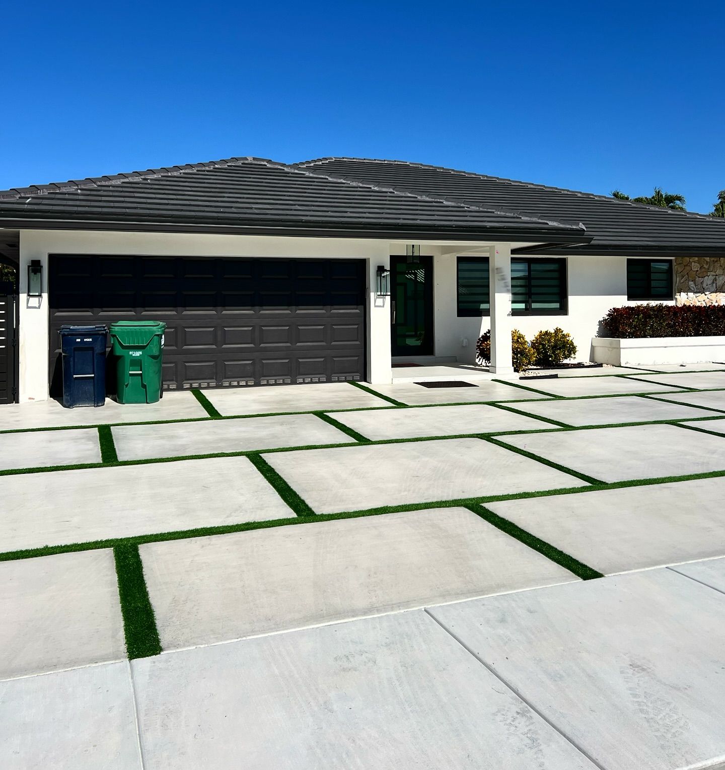 Modern home with a new concrete paver-style driveway and turf joints